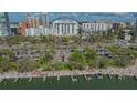 Scenic aerial view showcases waterfront apartments, boat docks, and lush landscaping for tranquil bayside living at 101 S Gulfstream Ave # 4J, Sarasota, FL 34236
