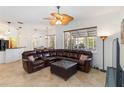 Spacious living room with tile floors, ceiling fan, and large sectional sofa at 10306 Palmbrooke Ter, Bradenton, FL 34202