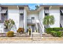 Charming condo exterior with gray shutters, brick accents, and beautiful landscaping for curb appeal at 1141 W Peppertree Dr # 1141, Sarasota, FL 34242