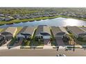 A picturesque view of the homes next to a large lake in the neighborhood with plenty of beautiful greenery at 14238 59Th E Cir, Bradenton, FL 34211