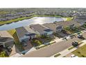A picturesque view of the homes next to a large lake in the neighborhood with plenty of beautiful greenery at 14238 59Th E Cir, Bradenton, FL 34211