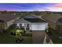 Charming single-story home with a well-manicured lawn, brick driveway, and attached two-car garage at 14238 59Th E Cir, Bradenton, FL 34211