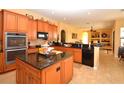 Open kitchen featuring granite countertops, stainless steel appliances, and ample storage at 15484 Alsask Cir, Port Charlotte, FL 33981