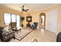 Elegant living room featuring tile floors, neutral colors, and sliding glass doors at 15484 Alsask Cir, Port Charlotte, FL 33981