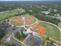 Aerial view of a baseball park with multiple well-maintained fields, parking and beautiful surrounding landscape at 17 Fears St, North Port, FL 34288