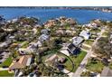 Aerial view of waterfront community featuring lush landscaping and mature trees surrounding each home at 1838 Sandalwood Dr, Sarasota, FL 34231