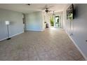 An open-concept living area boasts tile flooring and a sliding glass door for natural light and easy access to the backyard at 2105 Pueblo Cir # V2, Sarasota, FL 34231