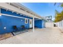 A cozy backyard patio area with outdoor seating offers a relaxing space with a convenient outdoor shower at 2408 Avenue B, Bradenton Beach, FL 34217