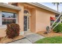 Inviting front entrance featuring decorative door, stone accents, and well-maintained landscaping at 4302 Turnberry Ct, Bradenton, FL 34210
