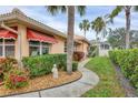 Landscaped yard featuring a winding walkway and lush greenery adds to this home's curb appeal at 4302 Turnberry Ct, Bradenton, FL 34210