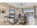 Bright living room with neutral decor, tile floors, and large windows offering scenic views at 4719 Cabreo Ct, Bradenton, FL 34211