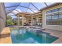 Inviting screened-in pool and spa area with outdoor kitchen perfect for entertaining at 4719 Cabreo Ct, Bradenton, FL 34211