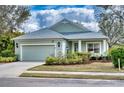 Charming single-story home featuring a two-car garage, lovely landscaping, and a cozy front porch at 4907 Torrey Pines Run, Bradenton, FL 34211