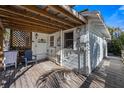 Outdoor rear deck with open roof, wood flooring and casual seating area at 520 Spring Ave # A, Anna Maria, FL 34216