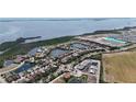 Aerial view of a community featuring waterfront homes, lush landscaping, community pond, and desirable location at 5628 Summit Point Cir # 103, Bradenton, FL 34210