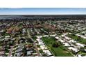 Overhead view of a neighborhood featuring well-maintained homes and a large body of water in the distance at 6608 13Th Avenue W Dr, Bradenton, FL 34209