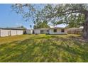 Expansive backyard with lush green grass, a shed, and a white privacy fence at 7104 13Th E St, Sarasota, FL 34243