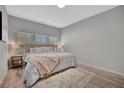 Bedroom with a large bed, light-colored walls, and wood laminate flooring at 720 26Th W St, Bradenton, FL 34205