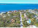 Aerial view of a home in a neighborhood near a waterway, with houses with pools visible in the distance at 7717 27Th W Ave, Bradenton, FL 34209