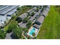 Aerial view showcasing community with pool, parking, and green spaces at 8850 Christie Dr, Largo, FL 33771