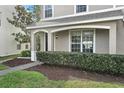 Inviting front entrance to home featuring decorative shrubs and covered porch at 8850 Christie Dr, Largo, FL 33771