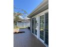 Inviting outdoor patio with sliding glass doors, ideal for enjoying the serene backyard at 935 Shasta Rd, Venice, FL 34293