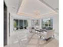 Elegant lobby with modern lighting, sleek seating, tiled floors, and large windows offering views of lush landscaping at 10520 Boardwalk Loop # 504, Lakewood Ranch, FL 34202