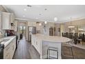 Spacious kitchen with an island and bar stool seating overlooks a formal dining area at 11050 Sandhill Preserve Dr, Sarasota, FL 34238