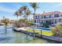 Waterfront property with a pool, dock, and lush landscaping, perfect for outdoor living at 1137 N Lake Shore Dr, Sarasota, FL 34231