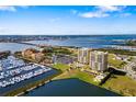 Aerial view of two condo buildings with boat docks and bridge access to waterfront community at 130 Riviera Dunes Way # 1201, Palmetto, FL 34221