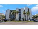 Multi-story condo building near the beach with private balconies and well-maintained landscaping at 1300 Gulf Blvd # 202, Indian Rocks Beach, FL 33785