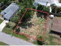 Aerial view of vacant lot showing property lines with nearby neighborhood and landscaping at 16733 Carmine Rd, Venice, FL 34293