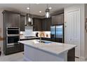 Modern kitchen featuring an island, stainless steel appliances, and pendant lighting at 209 Okeeffe Cir, Bradenton, FL 34212