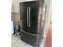 A refrigerator with black exterior and stainless steel handles in the kitchen at 216 Amherst Ave # 97, Sarasota, FL 34232