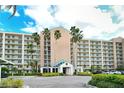 Grand condo building entrance with palm trees, covered drop off, and ample parking at 2320 Terra Ceia Bay Blvd # 808, Palmetto, FL 34221