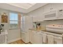 Bright kitchen features granite countertops, white cabinetry, modern appliances and a view from the window at 2320 Terra Ceia Bay Blvd # 808, Palmetto, FL 34221