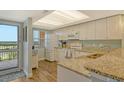 Bright kitchen features granite countertops, stainless steel appliances, wood floors, and scenic views at 2320 Terra Ceia Bay Blvd # 808, Palmetto, FL 34221
