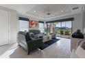 Living room featuring stylish furniture, neutral tile flooring and a ceiling fan at 3008 Tolmino Ct, Lakewood Ranch, FL 34211