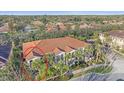 Aerial view of a multi-unit building with a terracotta roof and mature trees at 3760 82Nd Avenue E Cir # 101, Sarasota, FL 34243