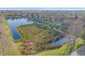 Scenic aerial view of a tranquil pond surrounded by lush greenery at 3760 82Nd Avenue E Cir # 101, Sarasota, FL 34243
