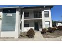 Condo building with visible unit number, a balcony, tidy landscaping, and neutral color scheme at 4440 47Th W Ave # 204, Bradenton, FL 34210