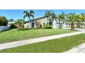 Home showcasing manicured lawn, swaying palm trees, and stone accents enhancing the curb appeal at 4712 Glenbrooke Dr, Sarasota, FL 34243