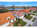 A beautiful house with a terracotta tiled roof and a well-maintained yard at 4811 Summertree Rd, Venice, FL 34293
