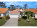 Well-maintained house showcasing a two-car garage, lush landscaping and a beautifully manicured lawn at 4811 Summertree Rd, Venice, FL 34293