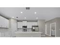 Open-concept kitchen featuring white cabinets and stainless steel appliances at 5 Debrita Rd, North Port, FL 34291