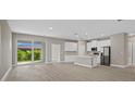 Bright living room with light wood flooring and access to the backyard at 5 Debrita Rd, North Port, FL 34291