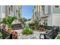Attractive townhome community with landscaped courtyard, benches, and decorative accents at 512 Laurel Park Dr, Sarasota, FL 34236