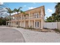 Beautiful two-story home with a welcoming balcony and a well-manicured lawn at 55 N Washington Dr, Sarasota, FL 34236