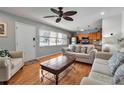Cozy living room featuring an open floor plan to the kitchen and large sunlit window at 5955 Midnight Pass Rd # 18E, Sarasota, FL 34242