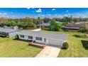 Aerial view of a well-maintained single-story home with lush lawn in a quiet neighborhood at 6349 5Th Street E Cir, Bradenton, FL 34203
